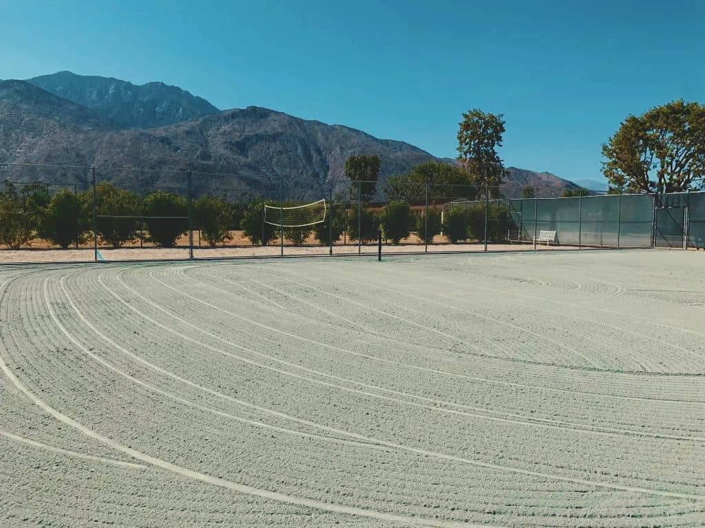 The same court, its clay fully de-compacted in even arcs